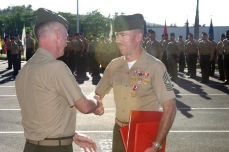 Commanding General congratulating me after pinning on Meritorious Service medal and retirement certificates.