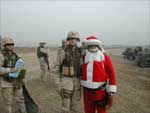 Click for a larger image of Dave Chesser with Santa in Iraq.